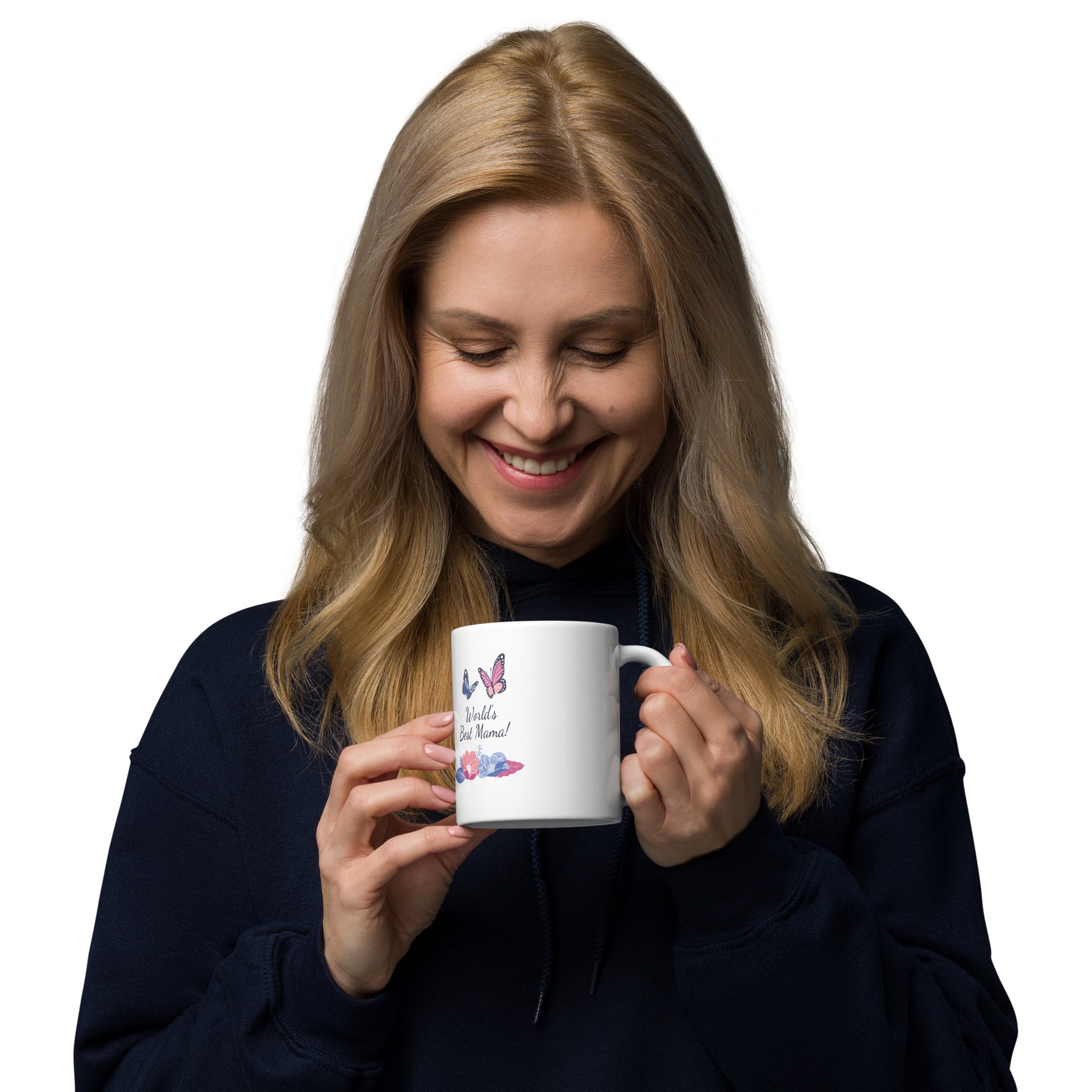 A smiling woman with long blonde hair in a dark hoodie holds a White glossy mug featuring butterflies and flowers, looking down at the dishwasher safe mug.